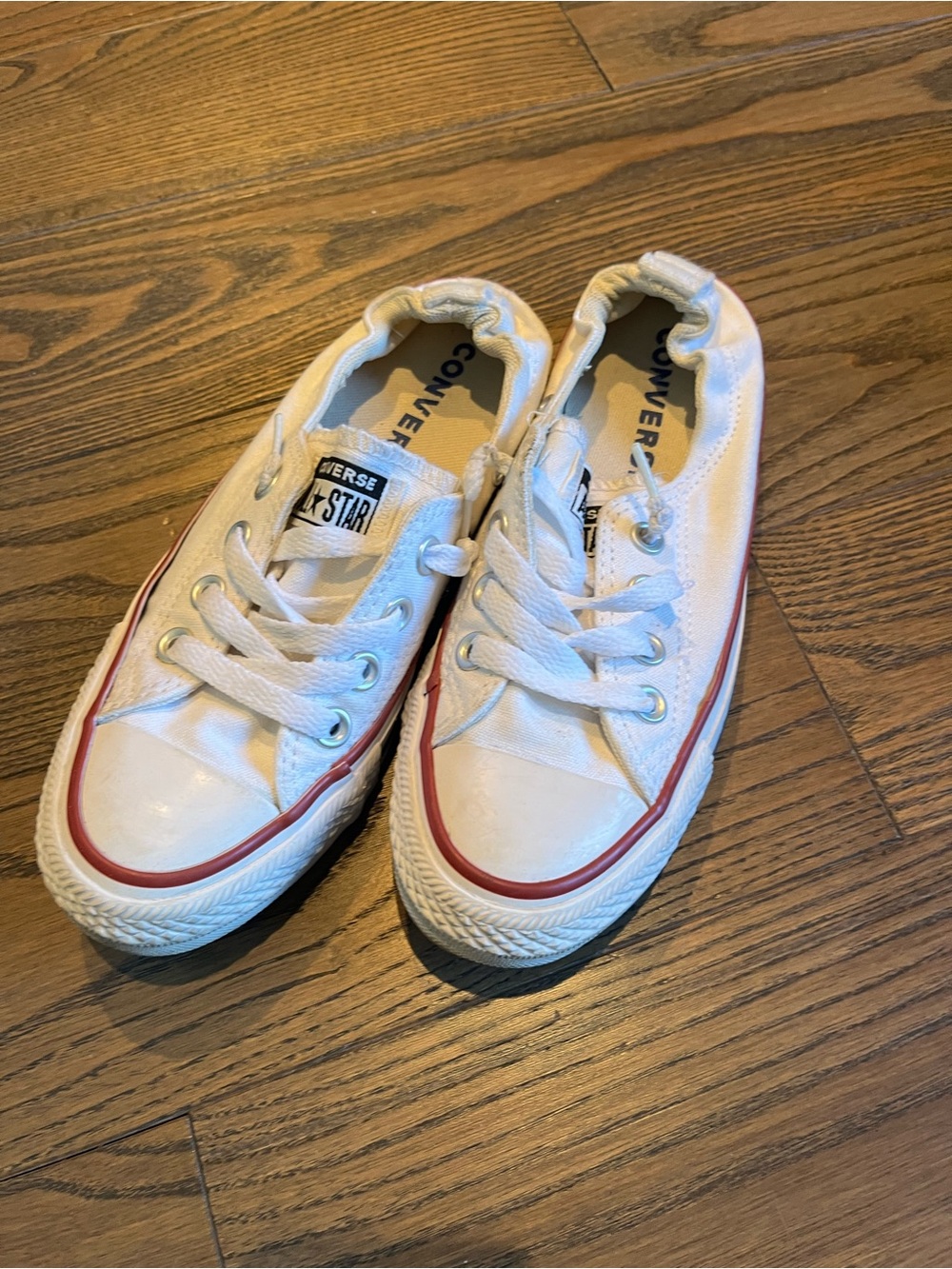 Converse women’s Low Top Canvas Sneakers in White with Red Trim